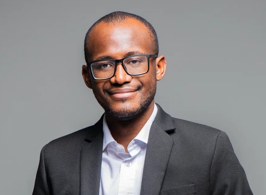Jesaya Hano-Oshike - The Brief | Namibia's Leading Business & Financial News Professional headshot of a man wearing a dark suit and glasses, smiling at the camera.
