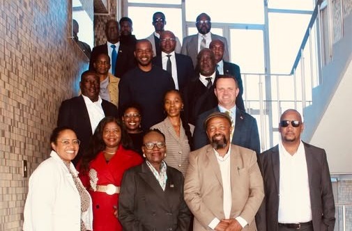 Group of diverse professionals posing on a staircase for a team photo on a corporate portrait.