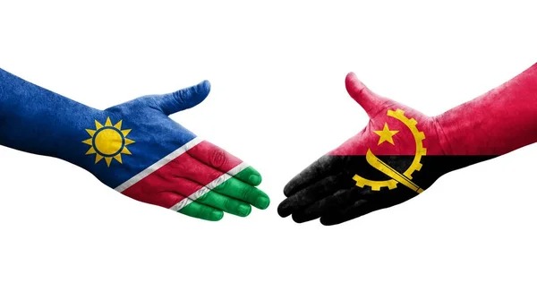 angola and Nam - The Brief | Namibia's Leading Business & Financial News Two hands painted with the Namibia and Angola flags reach toward each other for a handshake, symbolizing cooperation between the two countries.