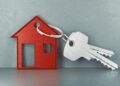 HOUSE KEYS - The Brief | Namibia's Leading Business & Financial News Red house-shaped keychain with a ring of two silver keys, symbolizing home ownership.