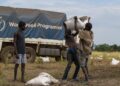 food progamme - The Brief | Namibia's Leading Business & Financial News Three men unload a white bag from a World Food Programme truck in a dry field.