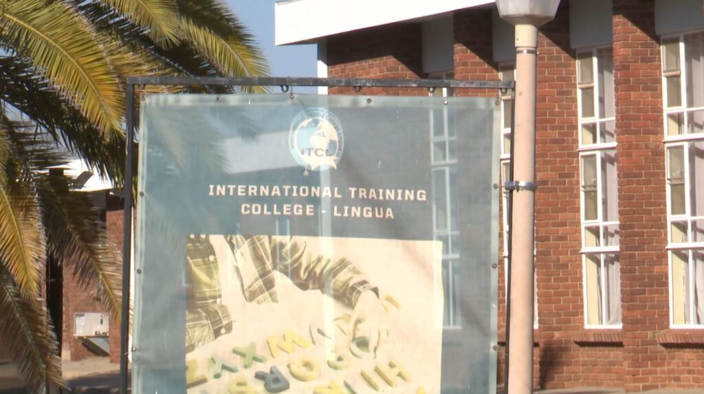 Banner for International Training College - Lingua on a campus with brick building and palm trees visible in the background