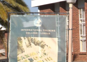 Banner for International Training College - Lingua on a campus with brick building and palm trees visible in the background