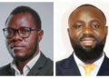 MixCollage-19-May-2026-12-05-PM-9824 - The Brief | Namibia's Leading Business & Financial News Two men in business attire: left man with glasses and short beard against a gray background; right man with a beard and yellow tie, smiling against a white background.