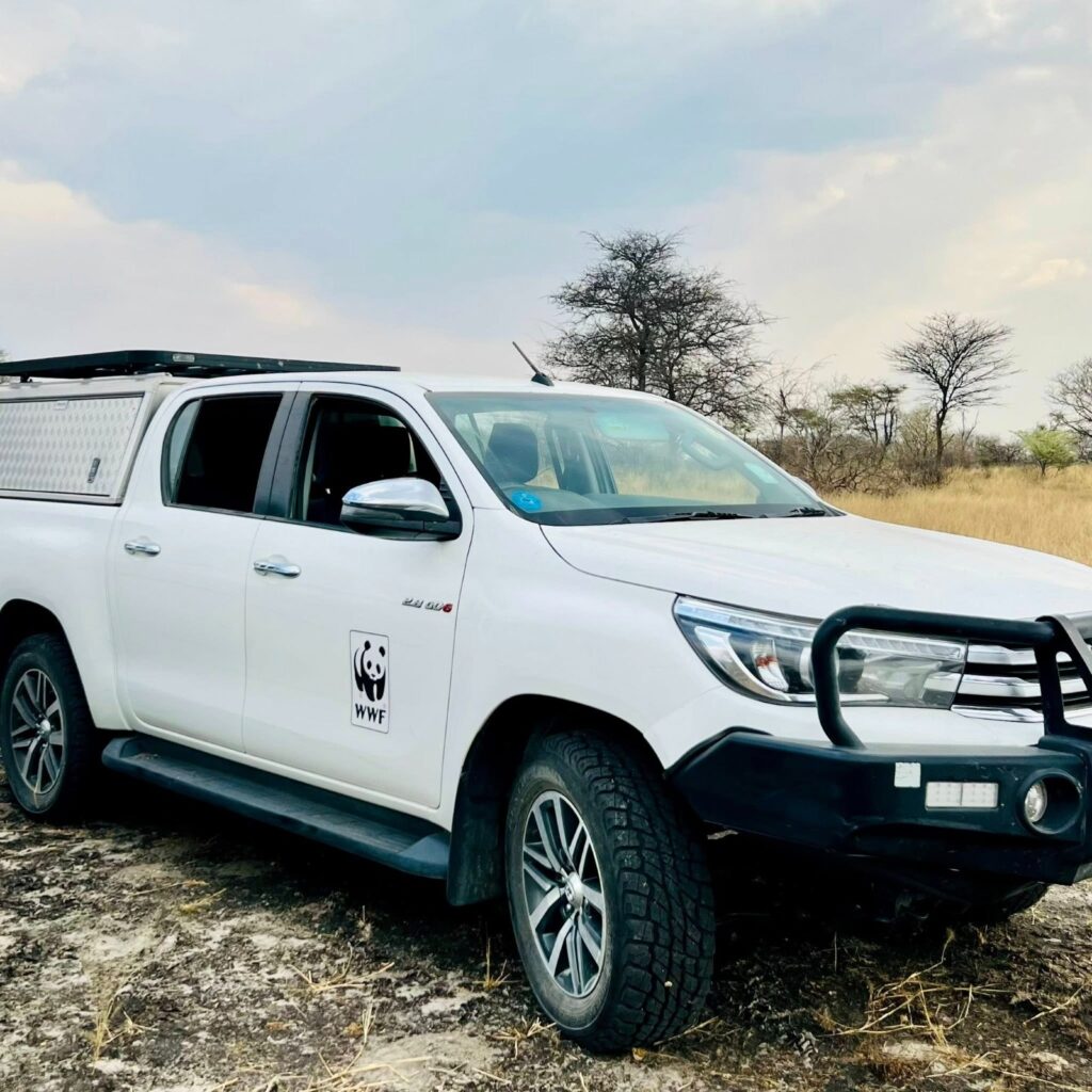 WhatsApp Image 2026-05-20 at 53418 PM - The Brief | Namibia's Leading Business & Financial News White WWF-branded pickup truck parked on a dry, grassy plain with leafless trees in the distance.