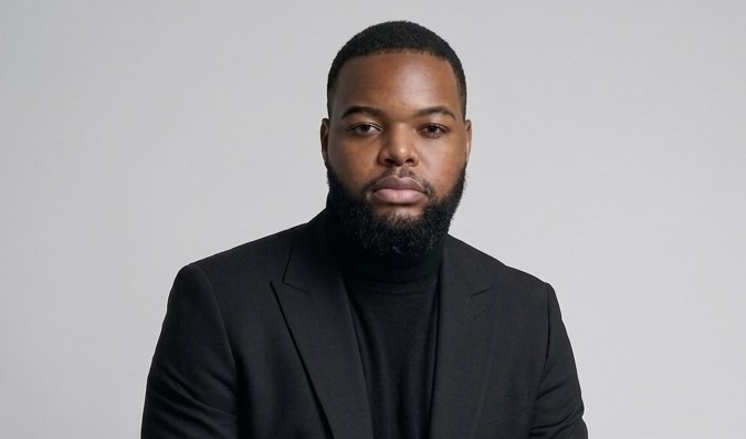 Willem Shikongo - The Brief | Namibia's Leading Business & Financial News Professional head-and-shoulders portrait of a man in a black blazer and turtleneck against a gray background.