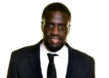 Portrait of a smiling African American man in a dark suit and black tie against a white background, a professional headshot.