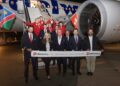 WhatsApp Image 2026-06-02 at 120029 PM - The Brief | Namibia's Leading Business & Financial News Group of airline staff posing in front of a parked Edelweiss airplane on the tarmac, holding a banner announcing the first flight Windhoek–Zurich on 01.06.2026, with Namibia and Swiss flags visible.