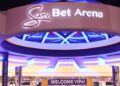SUN BET - The Brief | Namibia's Leading Business & Financial News Exterior view of the Sun Bet Arena entrance with purple neon lights and a circular overhang, giving a vibrant, glowing look at night.