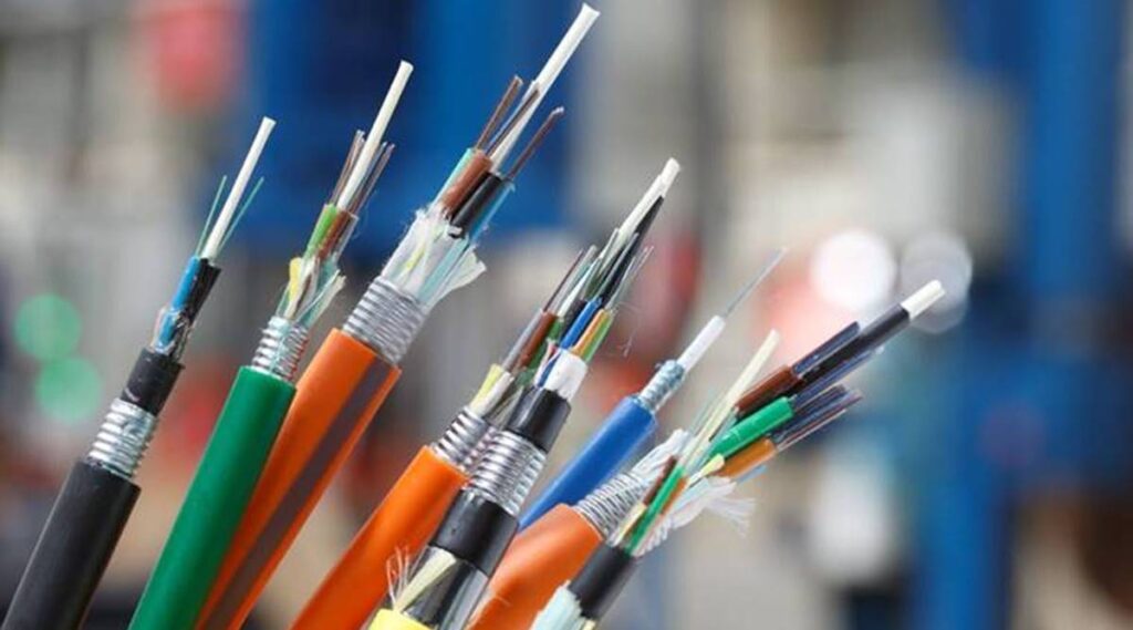 Close-up of several colorful electrical cables with stripped copper ends in a workshop environment (informative)