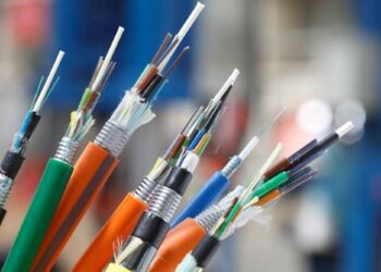 Close-up of several colorful electrical cables with stripped copper ends in a workshop environment (informative)