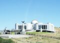 state house - The Brief | Namibia's Leading Business & Financial News White modern government building on a hill with a statue of an eagle on a pedestal in front, under a clear blue sky.