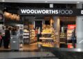 woolworths - The Brief | Namibia's Leading Business & Financial News Woolworths Food storefront interior with a central fruit and bread display and shoppers inside.