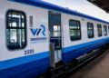 whk comuter service - The Brief | Namibia's Leading Business & Financial News Windhoek Commuter Service train in blue-and-white livery with door open at a station, car number 2305 visible on the side.