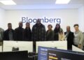 WhatsApp Image 2026-06-18 at 52049 PM - The Brief | Namibia's Leading Business & Financial News Group of coworkers posed in a Bloomberg office, smiling, with desks and computer monitors in the foreground.