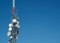WhatsApp Image 2026-05-22 at 60449 PM - The Brief | Namibia's Leading Business & Financial News Cellular communications tower with multiple satellite dishes and antennas against a clear blue sky.