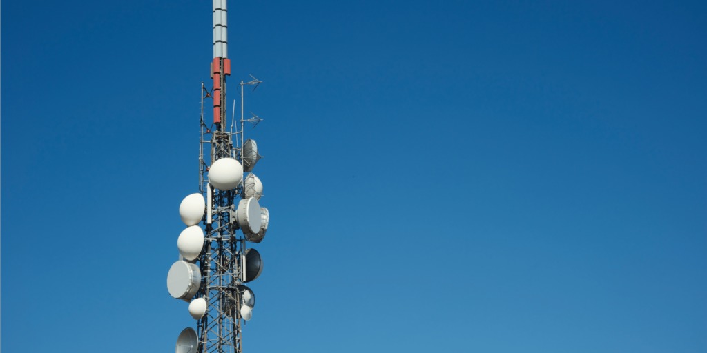 WhatsApp Image 2026-05-22 at 60449 PM - The Brief | Namibia's Leading Business & Financial News Cellular communications tower with multiple satellite dishes and antennas against a clear blue sky.