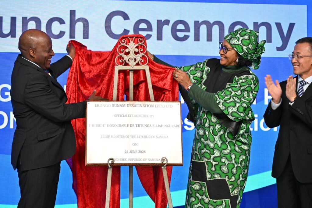 desalination - The Brief | Namibia's Leading Business & Financial News Two officials unveil a plaque on stage at a launch ceremony, with a woman in a green patterned outfit helping to remove the cloth.