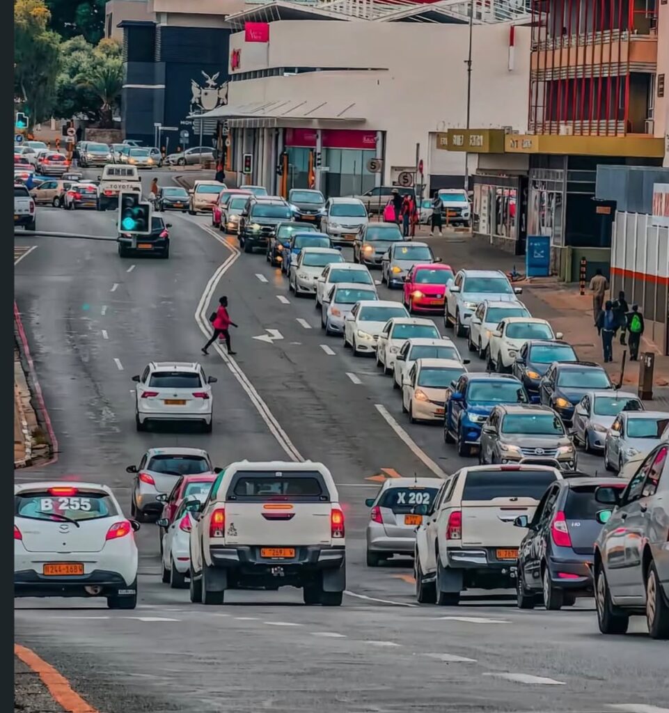 traffic - The Brief | Namibia's Leading Business & Financial News Busy city street jammed with cars in both directions and pedestrians crossing near storefronts on the right.