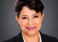 Colaindunn von Luttichau - The Brief | Namibia's Leading Business & Financial News Professional headshot of a smiling woman in a black blazer against a gray backdrop.