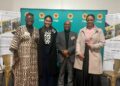 WhatsApp Image 2026-07-02 at 44228 PM - The Brief | Namibia's Leading Business & Financial News Four professionals posing and smiling at a corporate event with FNB banners in turquoise behind them, name tags visible.