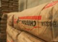 CHEETAH CEMENT - The Brief | Namibia's Leading Business & Financial News Stack of cement bags in a warehouse, beige packaging with red and black print