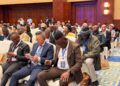 WhatsApp Image 2026-07-06 at 52915 PM - The Brief | Namibia's Leading Business & Financial News Audience of diverse professionals seated in a conference hall, some looking at phones, wearing lanyards and badges at a formal event.
