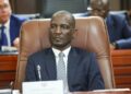 VEIKKO NEKUNDI - The Brief | Namibia's Leading Business & Financial News Man in a dark suit and striped tie seated in a brown leather chair at a formal meeting