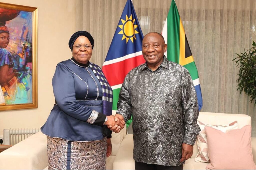 WhatsApp Image 2026-07-15 at 112544 AM - The Brief | Namibia's Leading Business & Financial News Two officials shake hands in a formal room, with the Namibian and South African flags behind them and a painting on the wall.