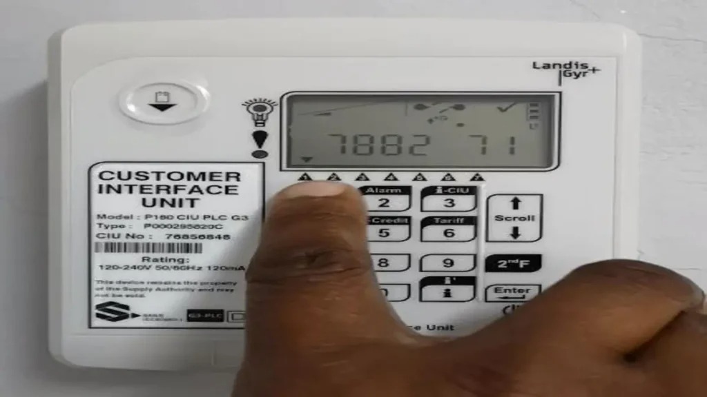 ELECTRICITY5 - The Brief | Namibia's Leading Business & Financial News Close-up of a white Customer Interface Unit with a numeric keypad; a finger presses a key while the display shows numbers.