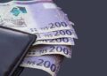 Money - The Brief | Namibia's Leading Business & Financial News Dark leather wallet with several 200 Namibian dollar notes peeking out