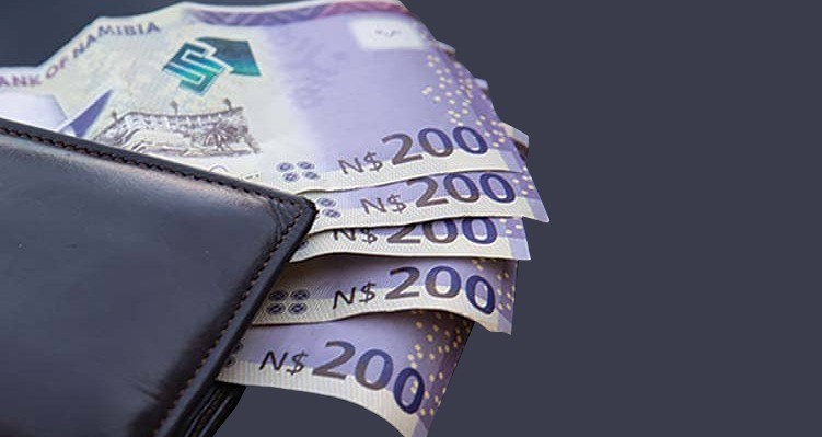 Money - The Brief | Namibia's Leading Business & Financial News Dark leather wallet with several 200 Namibian dollar notes peeking out