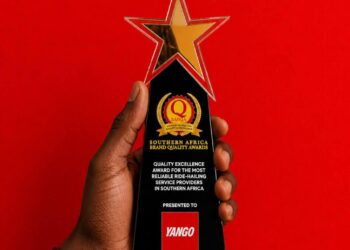 Trophy held in a hand against a red background, text reads 'Started from the bottom, now we're platinum' with YANGO as Platinum Winner 2026.
