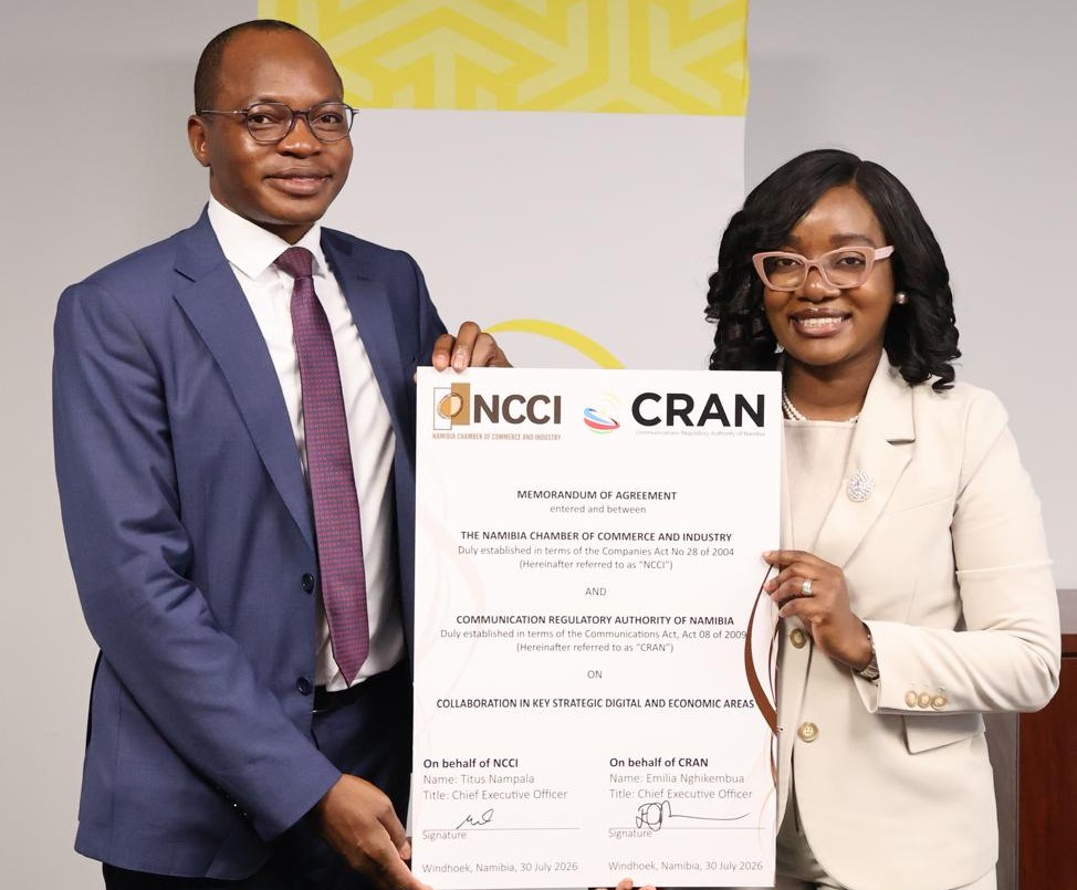 WhatsApp Image 2026-07-30 at 43723 PM - The Brief | Namibia's Leading Business & Financial News Two professionals in business attire hold a large Memorandum of Agreement featuring NCCI and CRAN logos during a signing ceremony.