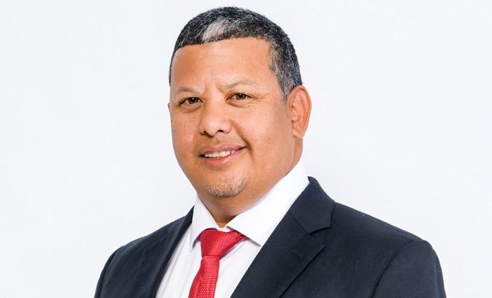 Willem Mouton - The Brief | Namibia's Leading Business & Financial News Professional headshot of a man in a dark suit and red tie against a white background.