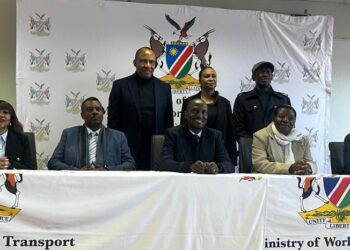 NAC - The Brief | Namibia's Leading Business & Financial News Group of seven officials seated at a long table with a Ministry of Work & Transport banner and crest behind them.
