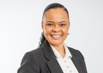 Isobel Manuel - The Brief | Namibia's Leading Business & Financial News Smiling woman in a dark blazer and white blouse against a light studio background.