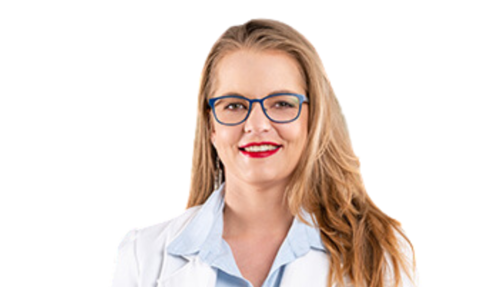 Smiling woman with blue-framed glasses and long light brown hair, wearing a light blue blouse against a white background.