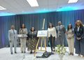 WhatsApp Image 2026-08-31 at 25613 PM - The Brief | Namibia's Leading Business & Financial News Group of eight professionals in formal attire on a stage with a DigiNam sign on an easel, unveiling a ceremony under blue curtain lighting.