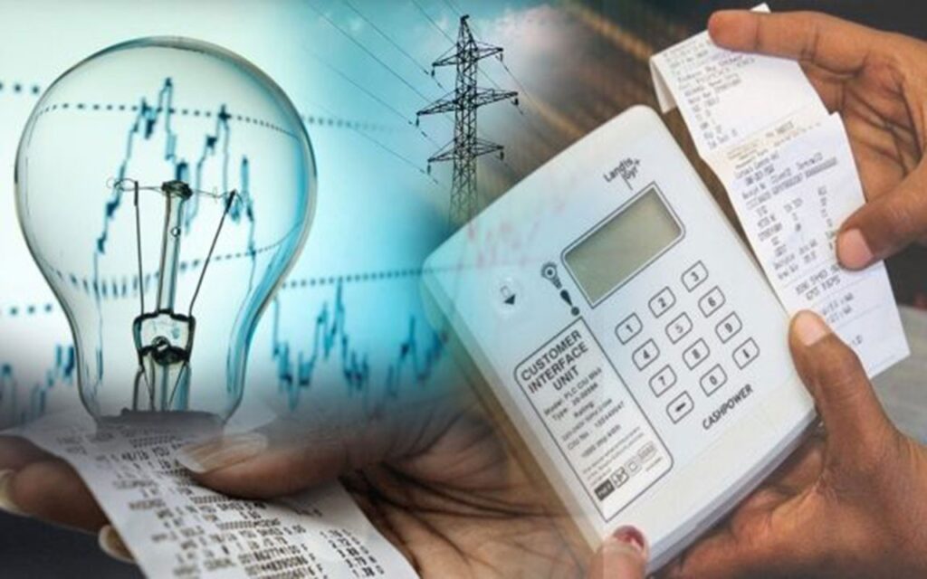 Receipt held beside a white card reader with a long energy bill, against a background of a glowing light bulb and power lines, suggesting electricity billing.