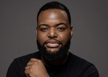 WILLEM SHIKONGO2 - The Brief | Namibia's Leading Business & Financial News Head-and-shoulders portrait of a man with a beard in a black shirt against a gray backdrop.