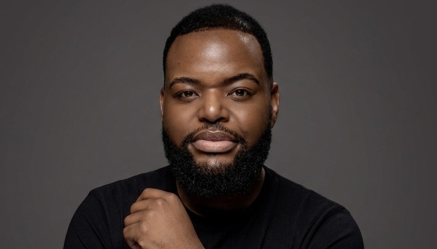 WILLEM SHIKONGO2 - The Brief | Namibia's Leading Business & Financial News Head-and-shoulders portrait of a man with a beard in a black shirt against a gray backdrop.