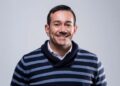 Paulo Coelho - The Brief | Namibia's Leading Business & Financial News Smiling man with short dark hair wearing a navy and gray striped sweater, light background.
