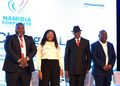 WhatsApp Image 2026-09-03 at 25150 PM - The Brief | Namibia's Leading Business & Financial News Four professionals on stage posing for a photo at a Namibia Corporate event, with a bright backdrop and branding visible behind them.