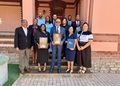 WhatsApp Image 2026-09-09 at 123731 PM - The Brief | Namibia's Leading Business & Financial News A group of professionals posing on steps outside a brick building, two people in front holding framed awards.