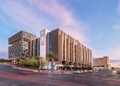 Modern office building with glass windows and logos (FNB, RMB, WesBank) on a corner street with palm trees at dusk/light.