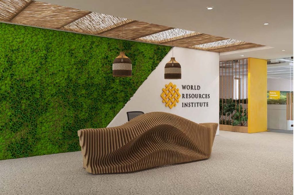 World Resources Institute - The Brief | Namibia's Leading Business & Financial News Reception lobby with a green vertical moss wall, curved wooden bench, and World Resources Institute logo on a white wall nearby