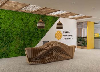 World Resources Institute - The Brief | Namibia's Leading Business & Financial News Reception lobby with a green vertical moss wall, curved wooden bench, and World Resources Institute logo on a white wall nearby