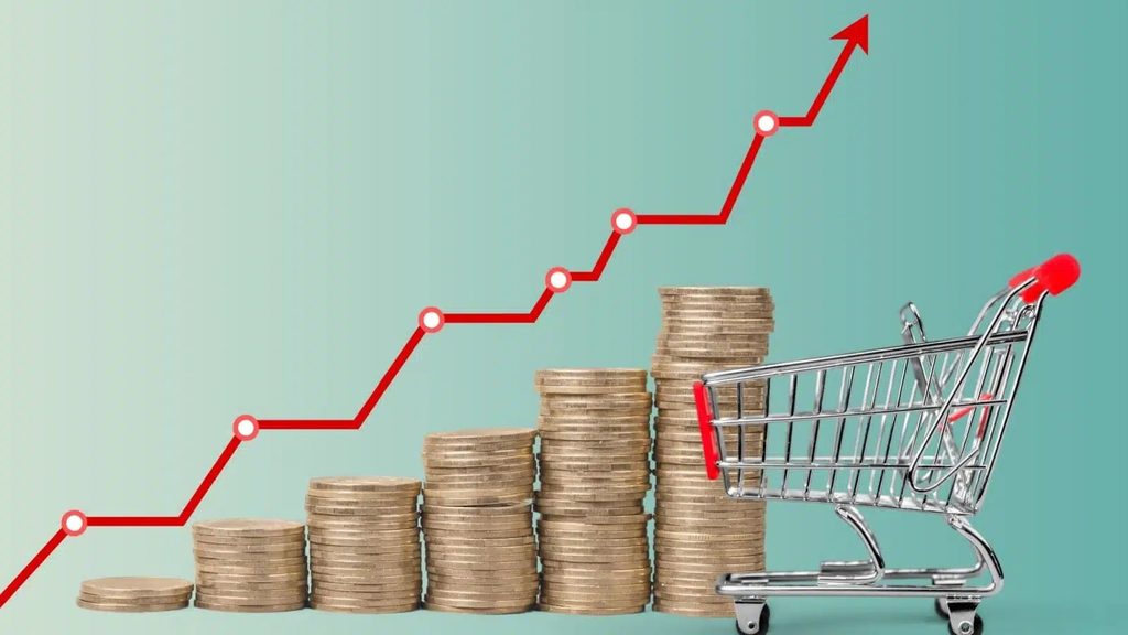 Stacked coins increasing in height beside a shopping cart, with a red upward growth line indicating rising value or costs.