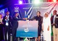 Officials on stage shake hands over a poster titled Ohangwena Region Investment Map and Action Plan at a formal ceremony